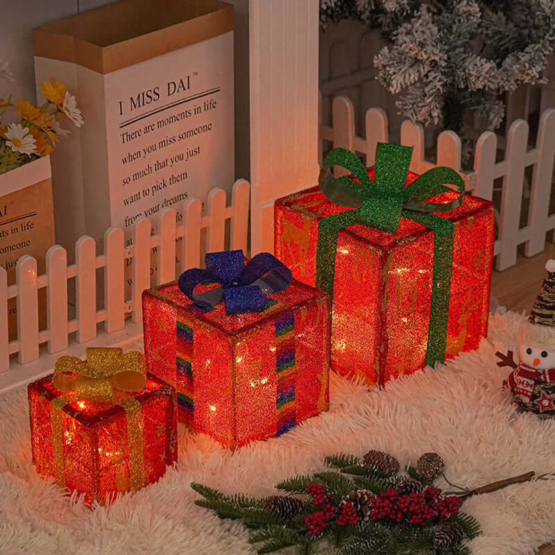 Outdoor Christmas Tree Luminous Gift Boxes decorated with colorful ribbons and stars, glowing warmly in a festive setting.