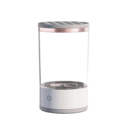 USB Automatic Eye Shadow Brush Cleaner in use with makeup brushes submerged in cleaning solution.