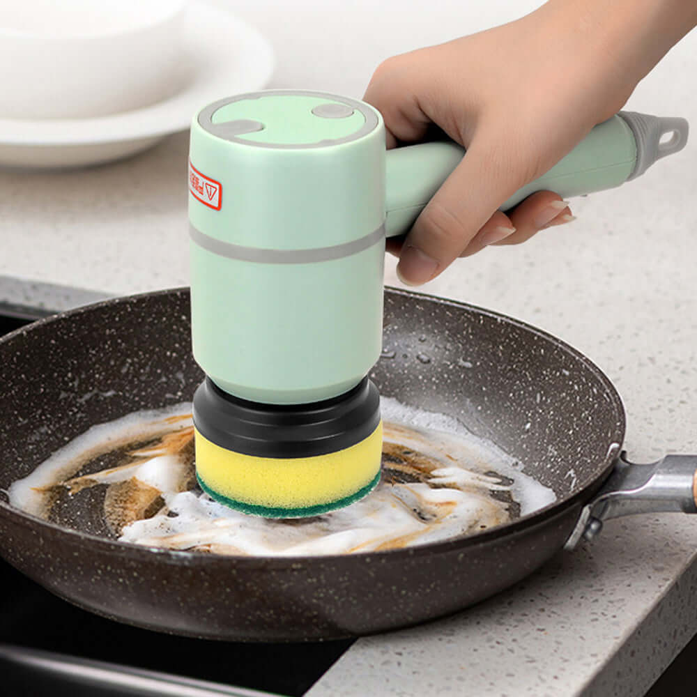 USB Rechargeable Automatic Kitchen Cleaning Brush in use for cleaning a stainless steel bowl with soapy water.