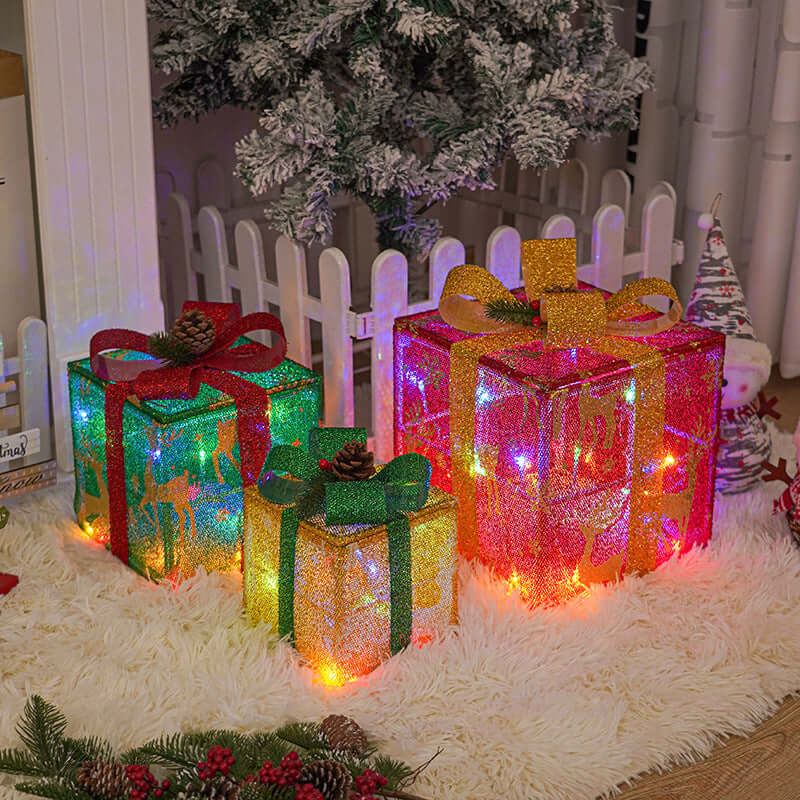 Outdoor Christmas Tree Luminous Gift Boxes decorated with colorful ribbons and stars, glowing warmly in a festive setting.
